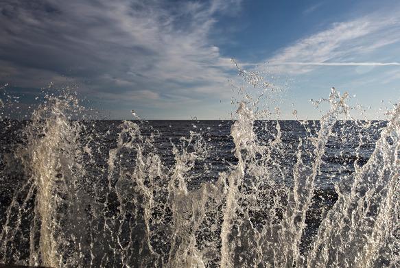 A splash of water with Lake Winnipeg in the background