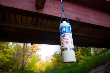 A sampling bottle hangs down from a bridge