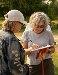 Image of someone completing a pledge form.
